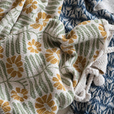 Woven Recycled Cotton Blend Throw with Flowers + Braided Pom Pom Tassels